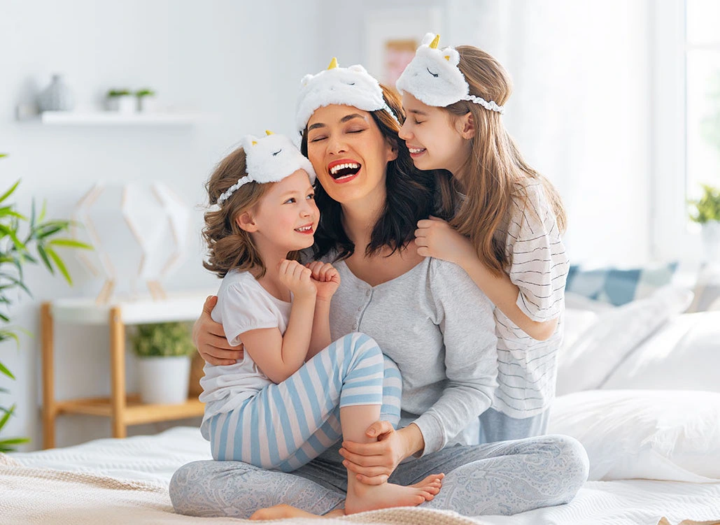 A mother and two daughters relaxing at home